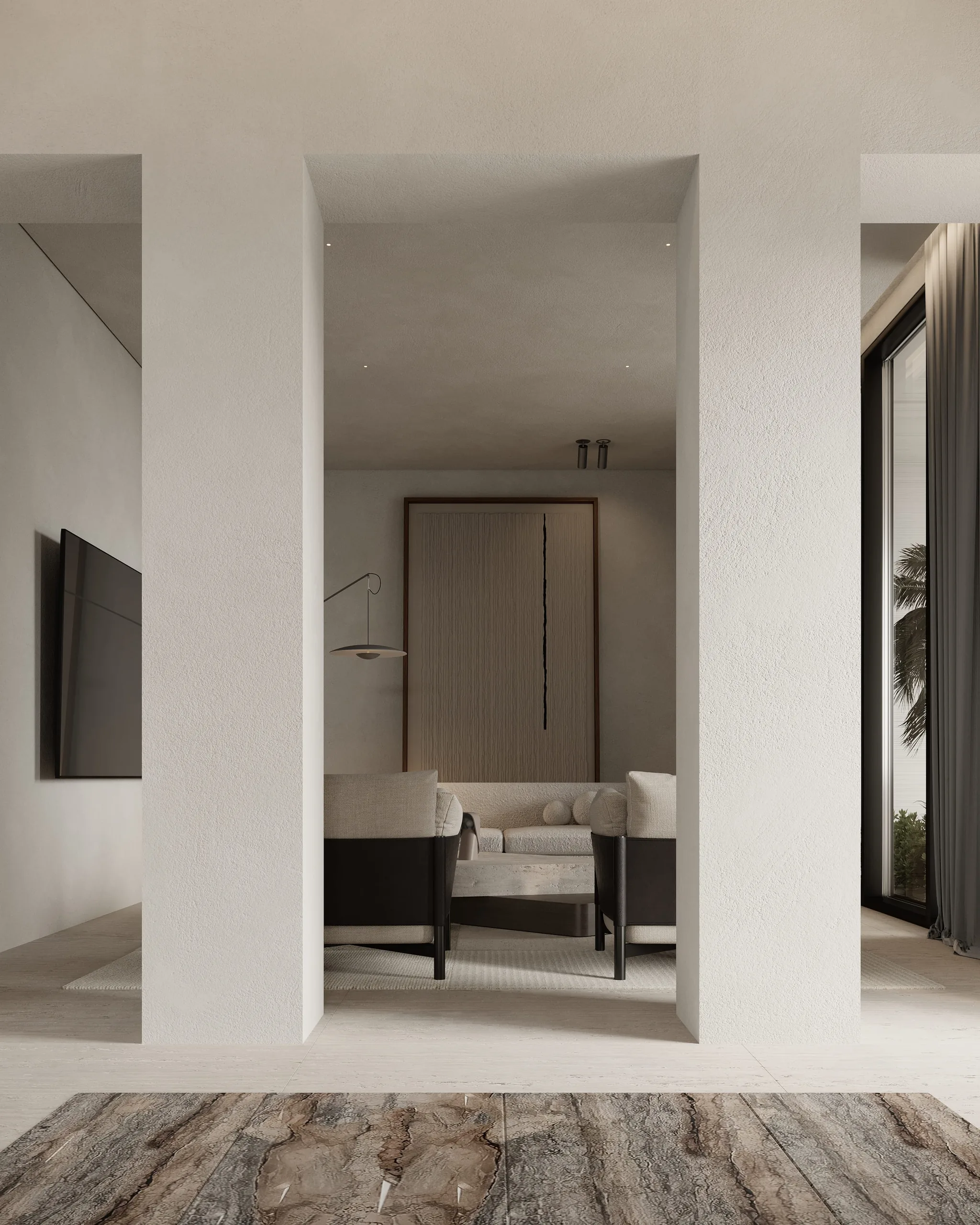 A calm living room seen between two plaster columns